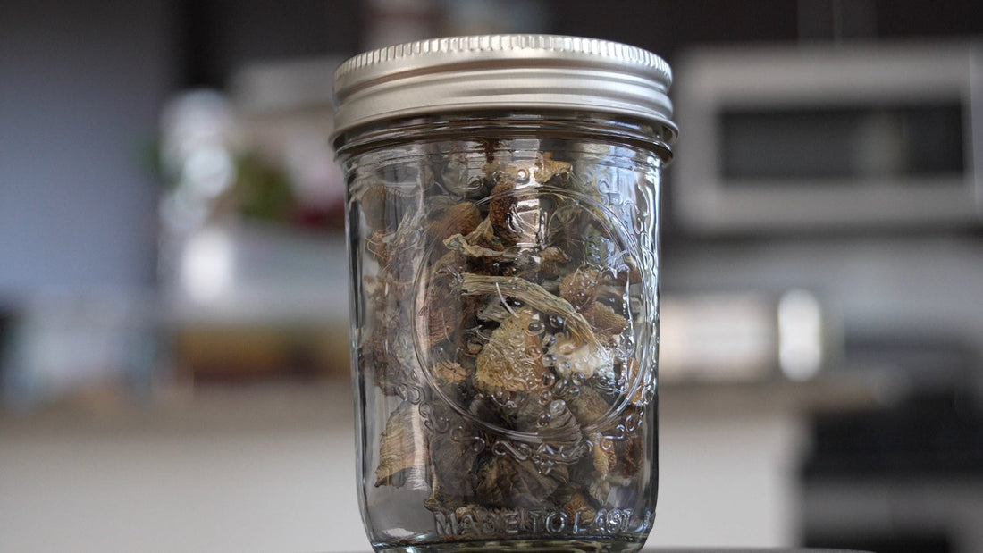 Dried mushrooms packed in a glass mason jar with a screw-top lid.